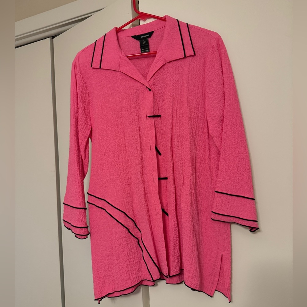 Bright pink blouse with black accents and fun buttons